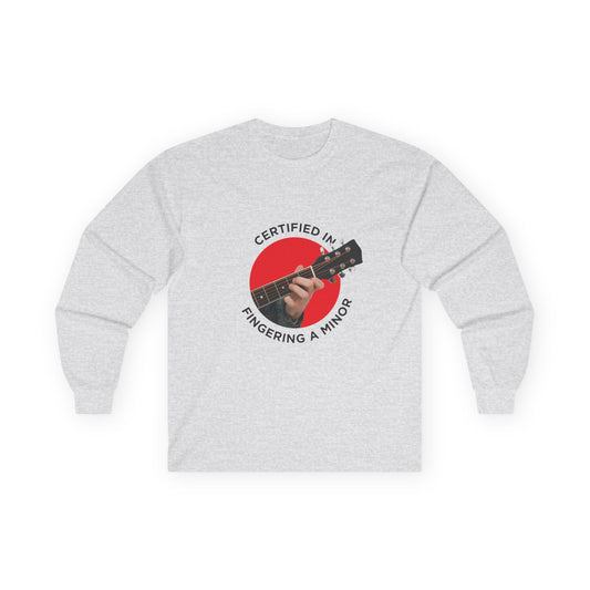 Funny t-shirt showing a hand fingering the A minor guitar chord with the phrase “Certified in Fingering A Minor,” cheeky pun for musicians.